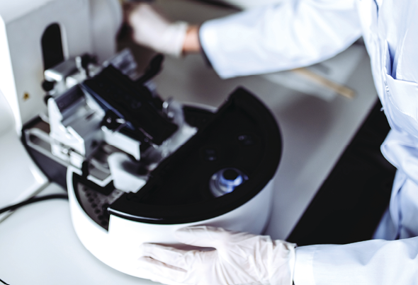 Scientist is working in laboratory. Young female researcher is doing investigations on laboratory equipment.